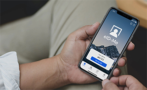 Holding a smartphone with the eID-Me digital identity mobile app.